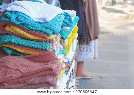 Counter With Knitwear On The Market Close-up. Market Street Trading. Woman Seller.