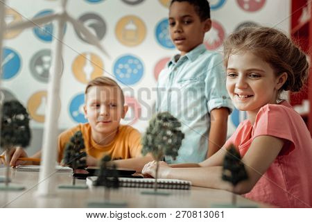 Charming Little Female Looking At Artificial Tree