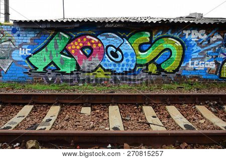 Full And Acomplished Graffiti Artwork. The Old Wall Decorated With Paint Stains In The Style Of Stre