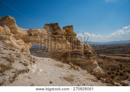 Unusual Rock On A Hill With A Hole. Beautiful Landscape In Sunny Autumn Weather. Cappadocia, Turkey