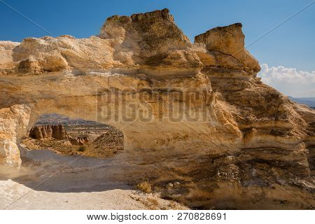 Unusual Rock On A Hill With A Hole. Beautiful Landscape In Sunny Autumn Weather. Cappadocia, Turkey