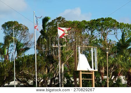 The Remains Of Shredded Us And Florida State Flags Blow In The Wind In The Aftermath Of Hurricane Ir