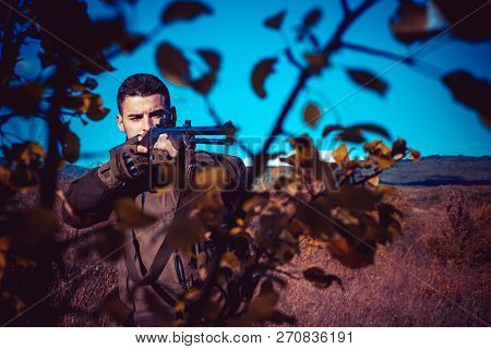 Hunter With Shotgun Gun On Hunt. Process Of Duck Hunting
