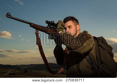 Hunter Aiming Rifle In Forest. Hunter With Shotgun Gun On Hunt. Hunter In The Fall Hunting Season. T