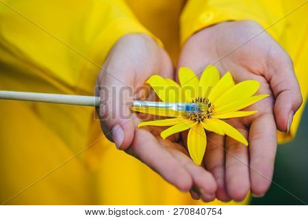 Spring Painting. Yellow Spring Mood. Flower On Hands. Girl Painting Flower. Spring Sensual Woman Wit