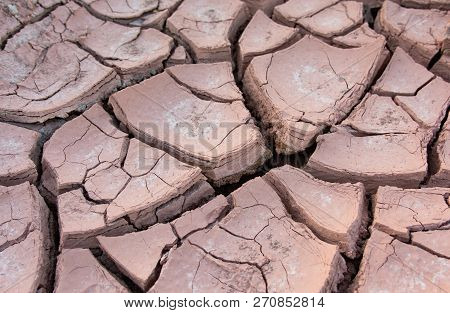 Cracked Earth, Cracked Soil. Texture Of Grungy Dry Cracking Parched Earth. Global Worming Effect.