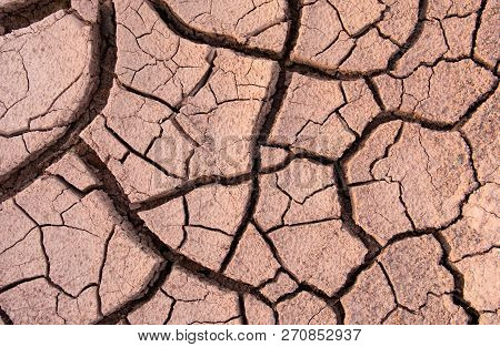 Cracked Earth, Cracked Soil. Texture Of Grungy Dry Cracking Parched Earth. Global Worming Effect.