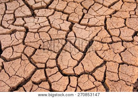 Cracked Earth, Cracked Soil. Texture Of Grungy Dry Cracking Parched Earth. Global Worming Effect.