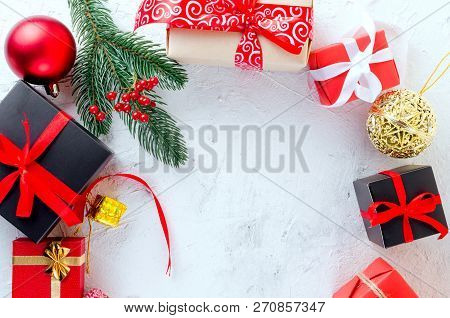 Christmas Decorative Background With Fir Branches, Cones, Redr And Black Christmas  Gifts, Ball On T