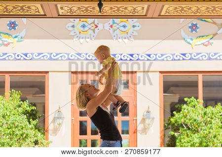 Woman Playing With Her Baby Outside. The Concept Of A Happy Full-fledged Family Life. Games With A C