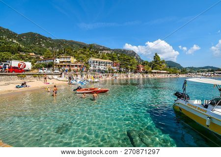 Corfu, Greece - September 16 2018: Tourists Relax In The Clear Waters And On The Sandy Palaiokastrit