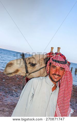Egyptian With His Camel Posing Against The Sea, June 8, 2008, Taba, Egypt
