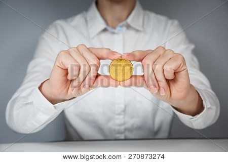 Golden Bitcoin In A Man Hand, Digitall Symbol Of A New Virtual Currency