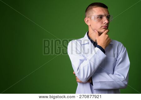 Young Handsome Man Doctor Wearing Protective Glasses Against Gre