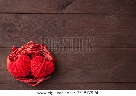 Two Red Hearts From Threads Lie In The Nest. Sweet Romantic Background. Valentines Day Concept. Sele