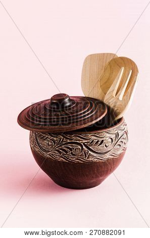 Pots And Plates Of Clay On A White Table And A Pink  Background. Clay Pottery Kitchen Utensils Made