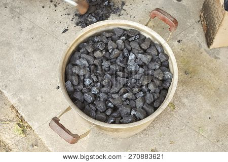 Black  In A Pan. Еhis Is Coal  For Better Coocing Stove.
