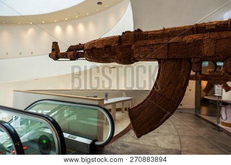 Fake Ak Kalashnikov Assault Rifle Hanging In Front Of Escalator In Contemporary Arts Museum