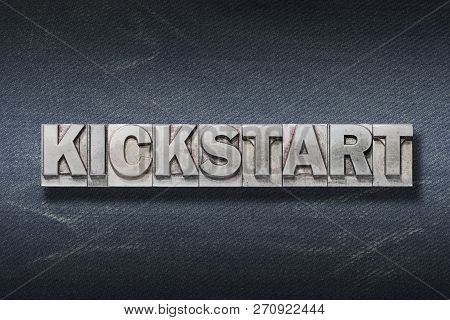 Kickstart Word Made From Metallic Letterpress On Dark Jeans Background