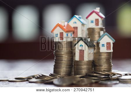Mini House On Stack Of Coins,money And House,  Mortgage, Savings Money For Buy House And Loan To Bus