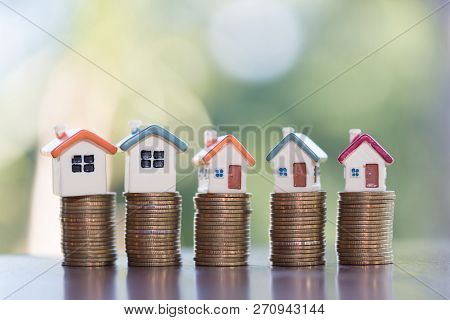Mini House On Stack Of Coins,money And House,  Mortgage, Savings Money For Buy House And Loan To Bus