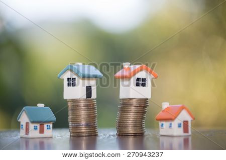 Mini House On Stack Of Coins,money And House,  Mortgage, Savings Money For Buy House And Loan To Bus