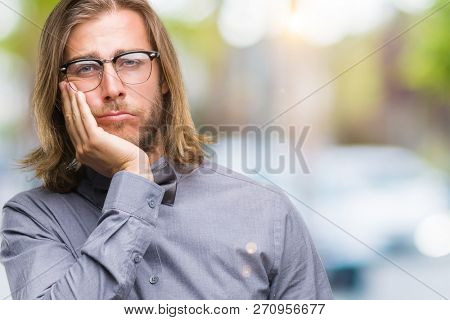 Young handsome man with long hair wearing bow tie over isolated background thinking looking tired and bored with depression problems with crossed arms.