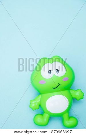 Childrens Toy Funny Green Frog Close-up, Isolated On A Blue Background. Macro.