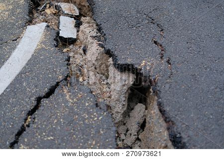 Crack On Asphault Rural Road. Damaged Collapsed Street