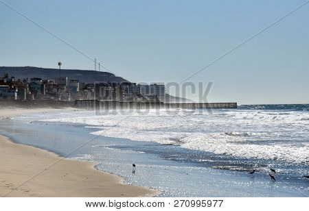 SAN YSIDRO, CALIFORNIA - NOVEMBER 26, 2018: Border Wall along the USA Mexico Border Wall at Imperial Beach where the wall extends into the Pacific, looking towards Tijuana.