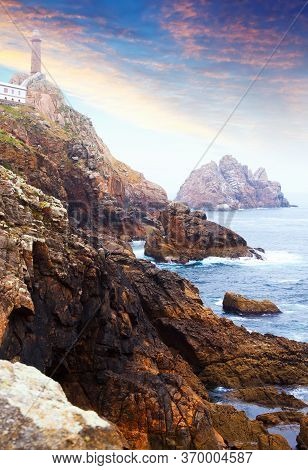 Ocean Rocky Coast With Lighthouse Of Vilan. Galicia, Spain