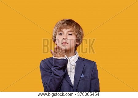 A Little Boy Sends An Air Kiss To The Camera.