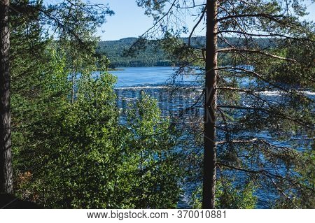 View Of Kalix River, Kalixalven, Overkalix Locality And The Seat In Norrbotten County, Sweden, With