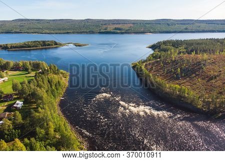 View Of Kalix River, Kalixalven, Overkalix Locality And The Seat In Norrbotten County, Sweden, With