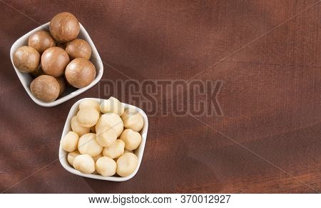 Organic Macadamia Nut On Wooden Table - Macadamia Integrifolia