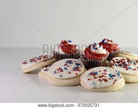 Patriotic Baked Goods, Sugar Cookies Covered With White Frosting And Red, White And Blue Sprinkles W