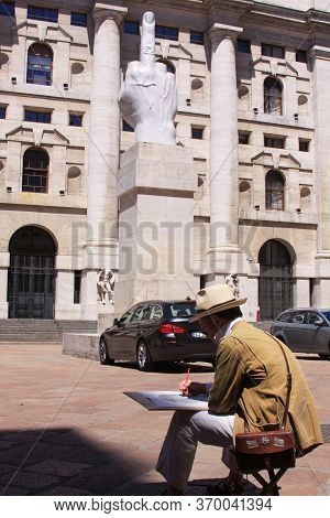 Milan, Italy - May 26, 2013: Street Artist Painting Middle Finger Statue In Milan, Italy, In Front O
