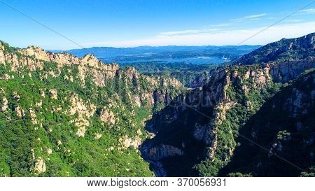Aerial View Of Mountain With Water Reservoir On The Background With Beautiful Blue Sky. Landscape Of