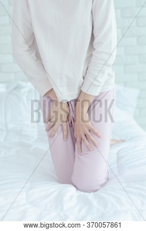 Close Up Woman Wearing Pink Pants The Itching On Vaginal. The Woman's Hand Placed Between Her Legs. 