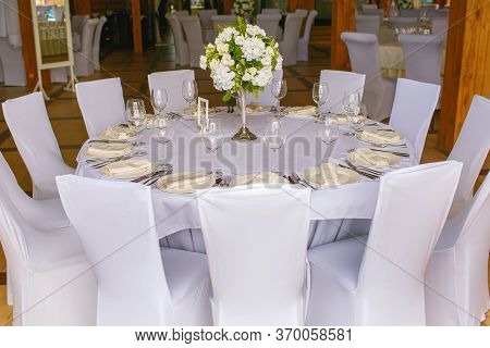 Table In The Restaurant, Served, Lots Of Chairs, Large Company.