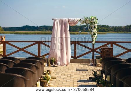 Wedding. Ceremony. Wedding Arch. Wedding Arch Made Of Branches, Flowers And Greenery Is On The Green