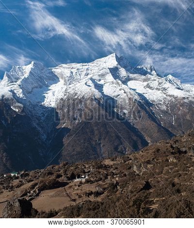 Panoramic View Of Kangtega And Thamserku Mountains And Buddhist Chorten With Prayer Flags On The Way