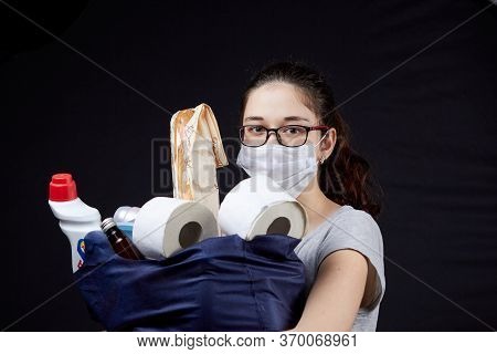 Young Woman In Protective Mask With A Bag Full Of Groceries From The Supermarket