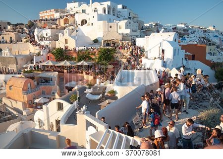 Santorini, Greece - July 18 2019: Beautiful Village Of Oia Crowded Full Of Tourists For The Sunset, 