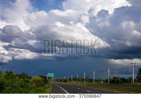 Black Rain Clouds Blew Through 4-lane Roads With High-voltage Electricity Poles.