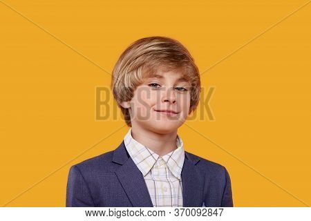 Beautiful Cute Boy With A Short Haircut And Blond Hair.