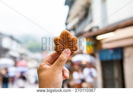 Hand Holding A Japanese Hiroshima Traditional Maple Leaf-shaped Cake, Momiji-manju.