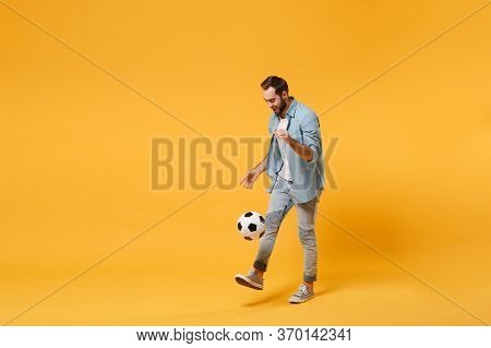 Young Man In Casual Blue Shirt Posing Isolated On Yellow Orange Wall Background, Studio Portrait. Pe