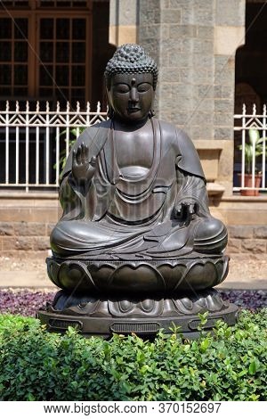 MUMBAI, INDIA - FEBRUARY 14, 2020: Statue of the Buddha at the entrance of the Prince of Wales Museum, now known as The Chhatrapati Shivaji Maharaj Museum in Mumbai, India