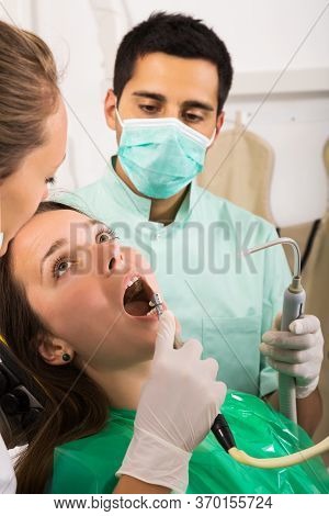 Dentist, Assistant And Woman Pyoung Atient At Surgery Office